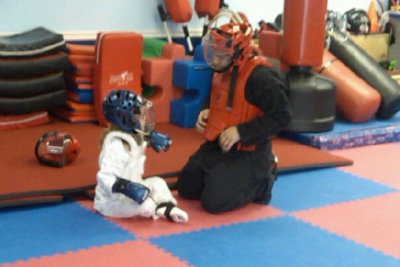 karate instructor teaching little girl